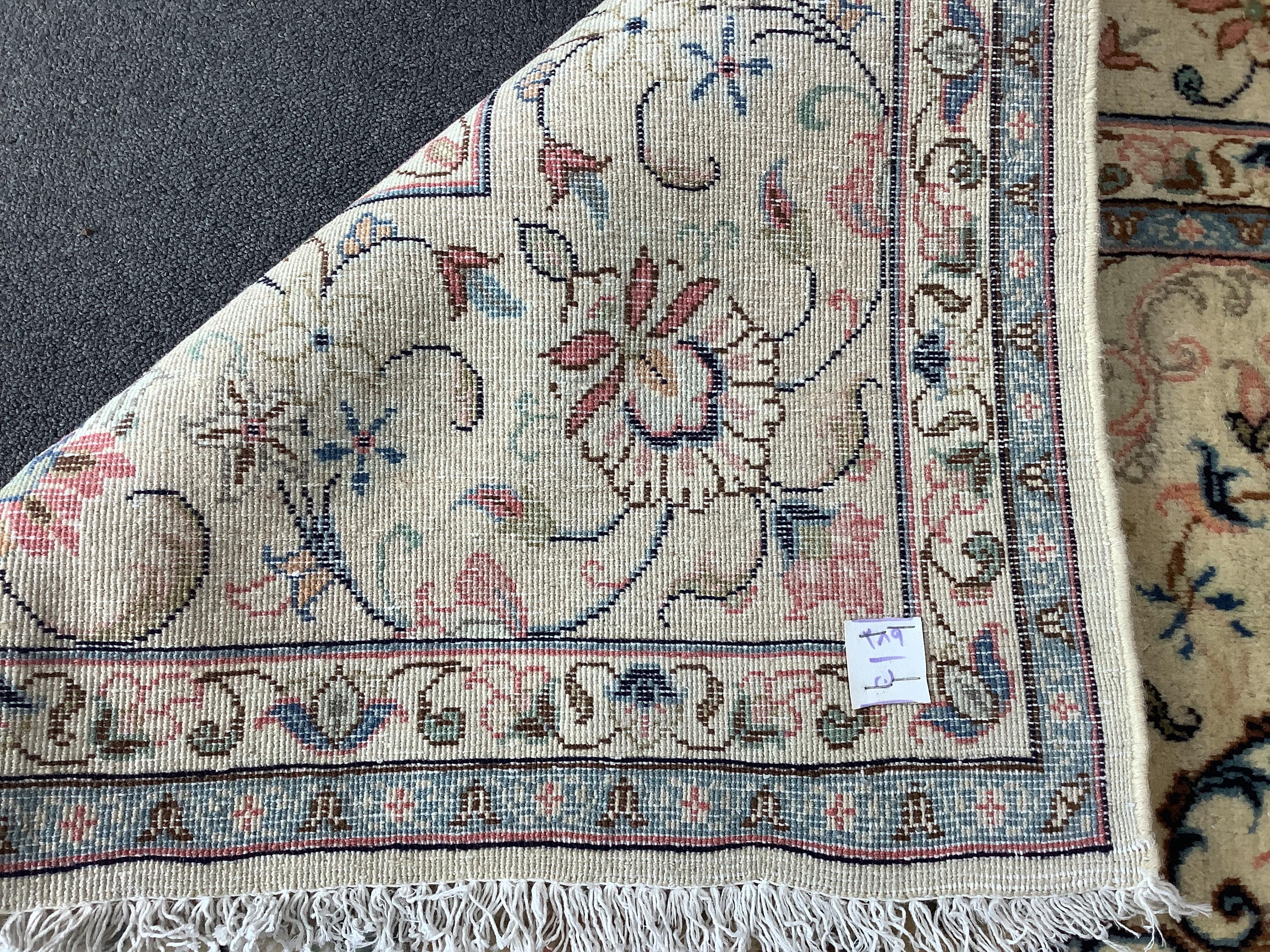 A Kashan ivory ground carpet, 306 x 197cm